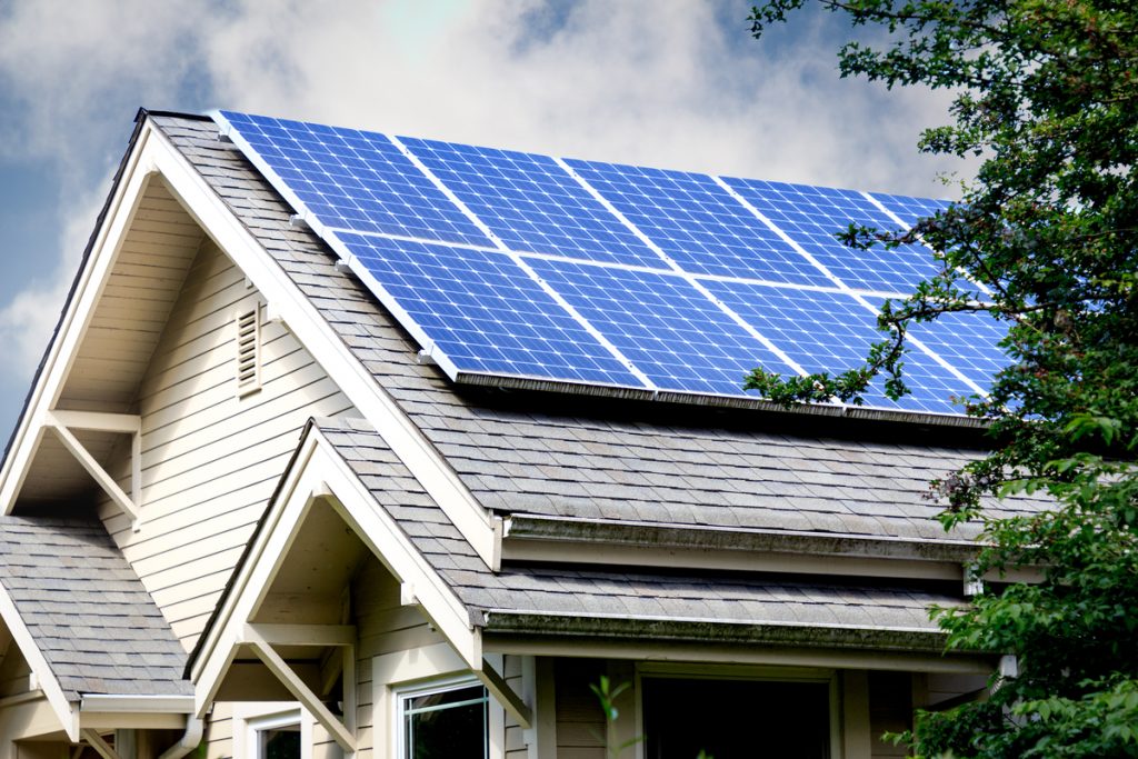 Solar panels on top of energy efficient home on a sunny day
